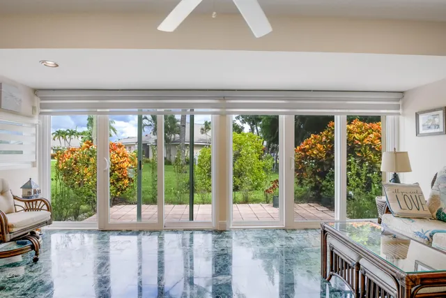 a view of backyard with a large window and potted plants