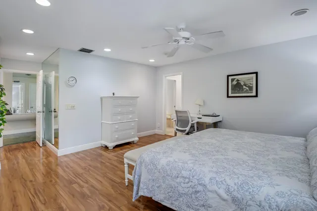 a bedroom with a bed and a view of kitchen