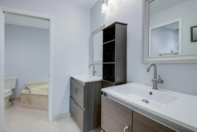 a view of bathroom with a sink and mirror