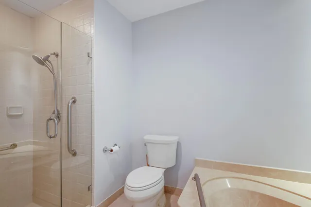 a bathroom with a toilet and shower