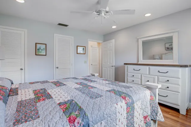 a bathroom with a granite countertop sink a toilet and a mirror