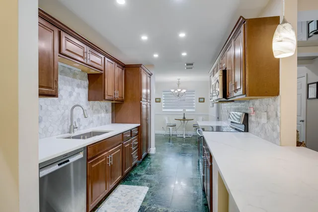 a kitchen with a sink appliances and cabinets
