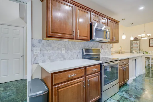 a kitchen with stainless steel appliances granite countertop a sink and cabinets