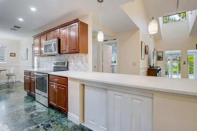 a kitchen with stainless steel appliances granite countertop a sink and a stove