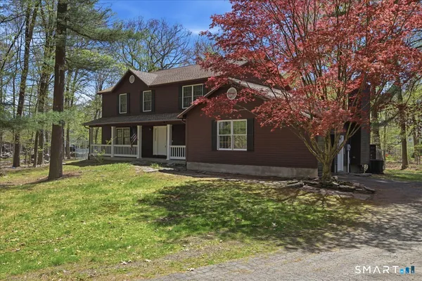 a view of backyard with outdoor seating and green space