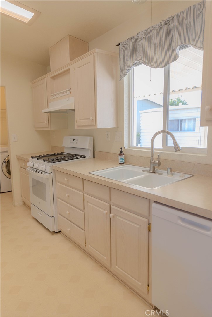 2140 Mentone, Unit 3 Mentone, CA 92359 - Photo 13 of 45 a kitchen with sink cabinets and window