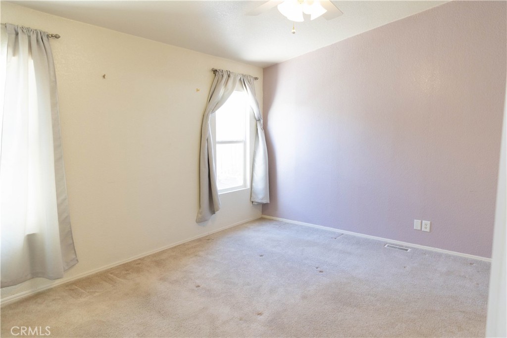2140 Mentone, Unit 3 Mentone, CA 92359 - Photo 14 of 45 an empty room with windows and closet