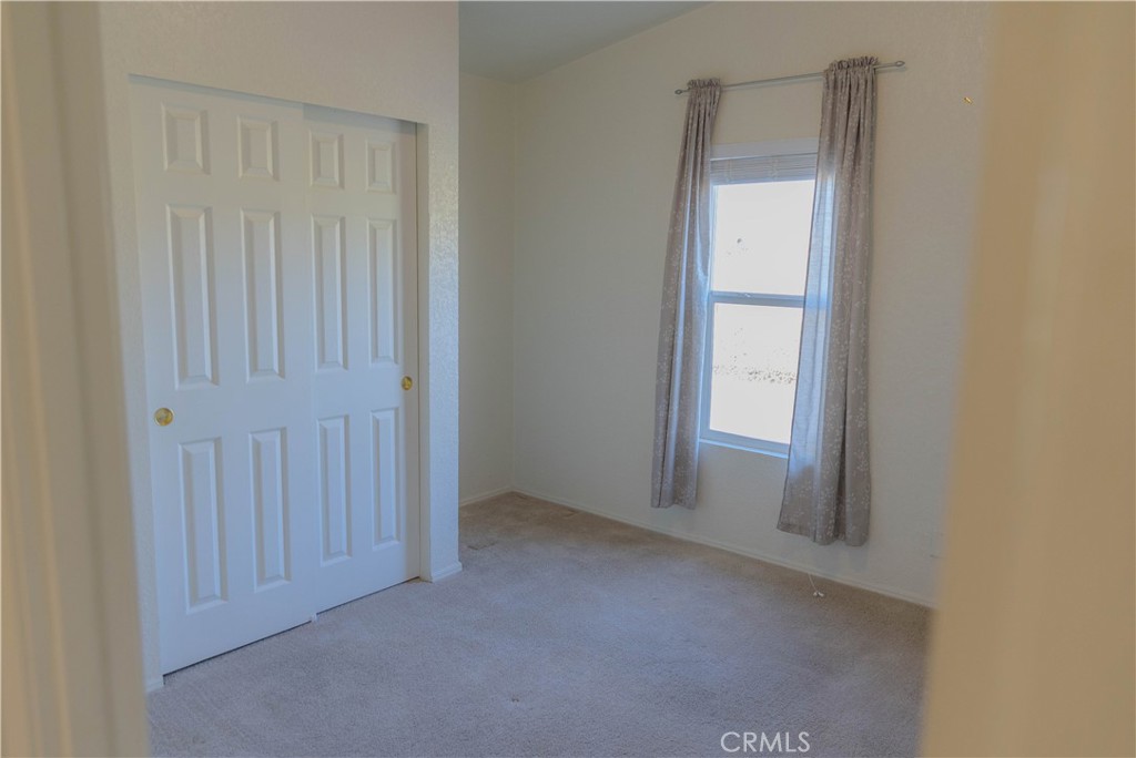 2140 Mentone, Unit 3 Mentone, CA 92359 - Photo 20 of 45 an empty room with windows