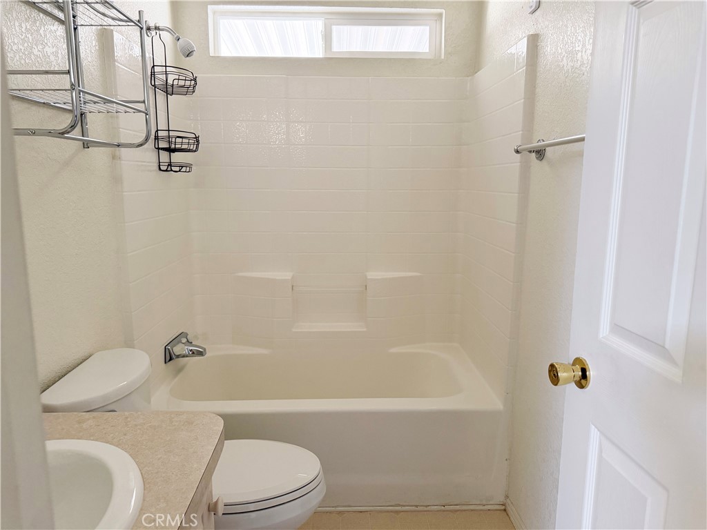 2140 Mentone, Unit 3 Mentone, CA 92359 - Photo 21 of 45 a bathroom with a toilet and a bath tub