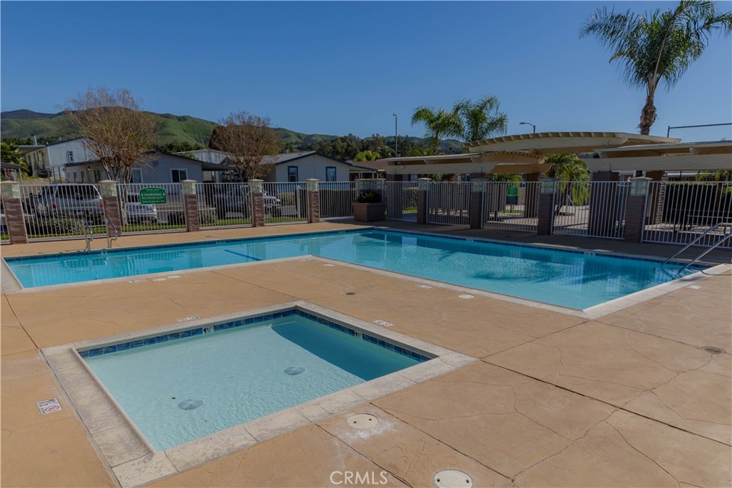 2140 Mentone, Unit 3 Mentone, CA 92359 - Photo 45 of 45 a view of swimming pool with a table and chairs under an umbrella