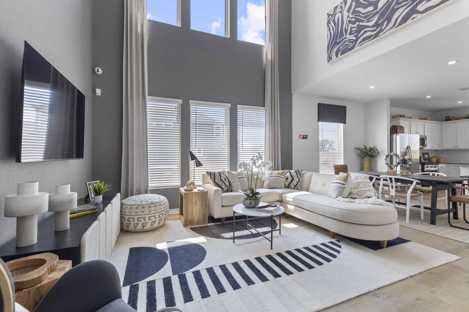 105 Hatari Trail Jarrell, TX 76537 - Photo 8 of 27 Double-height walls and oversized windows fill this open-concept main level with natural light.