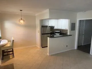 a kitchen with stainless steel appliances a refrigerator sink and stove