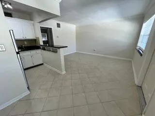 a kitchen with a sink and steel appliances