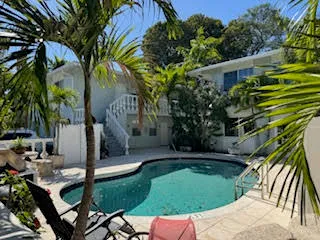 a view of backyard with swimming pool and outdoor seating