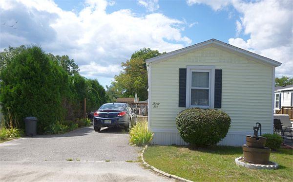 25 Groton School Road, Unit 35 Ayer, MA 01432 - Photo 1 of 6 a front view of a house with a garden