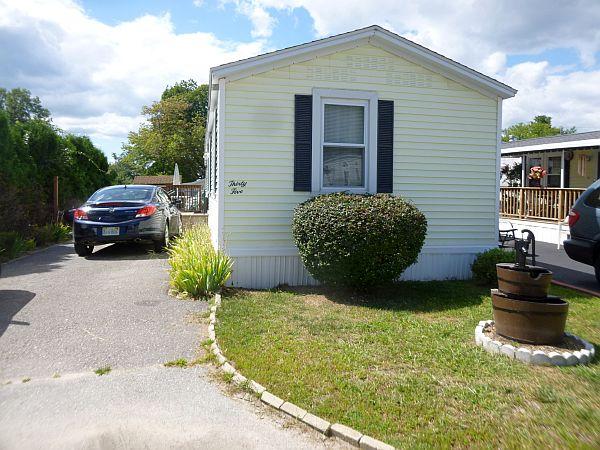 25 Groton School Road, Unit 35 Ayer, MA 01432 - Photo 2 of 6 a front view of a house with garden