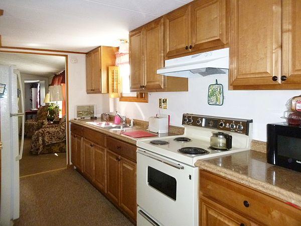 25 Groton School Road, Unit 35 Ayer, MA 01432 - Photo 5 of 6 a kitchen with a stove and a sink