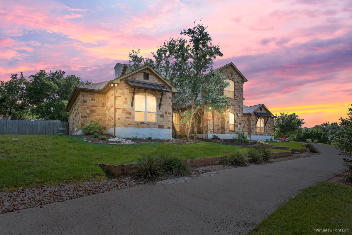 View of front of house with stone siding and a chimney