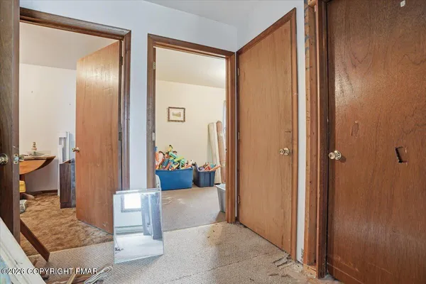 a view of an empty room with wooden walls