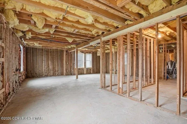 a view of empty room with wooden walls