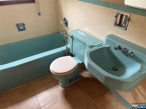 a bathroom with a sink mirror and toilet