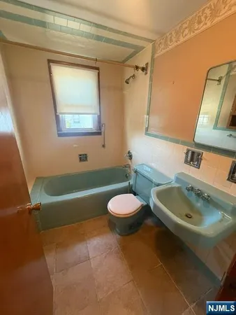 a bathroom with a sink a toilet and a bathtub