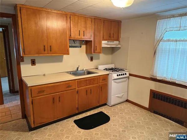 a kitchen with stainless steel appliances a stove a sink and a refrigerator