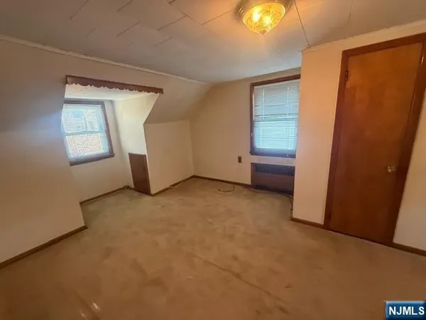 an empty room with windows and closet