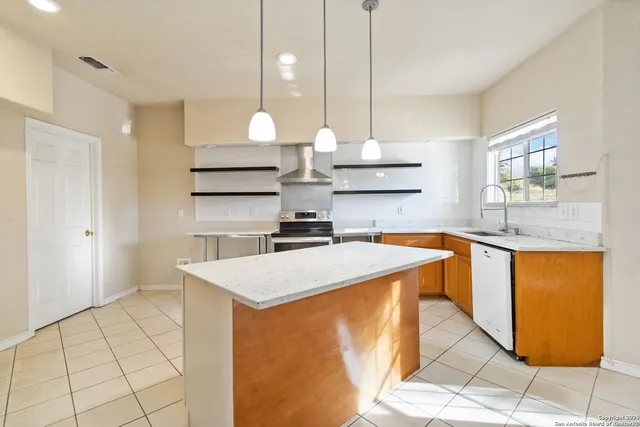 a kitchen with stainless steel appliances granite countertop a stove and a sink