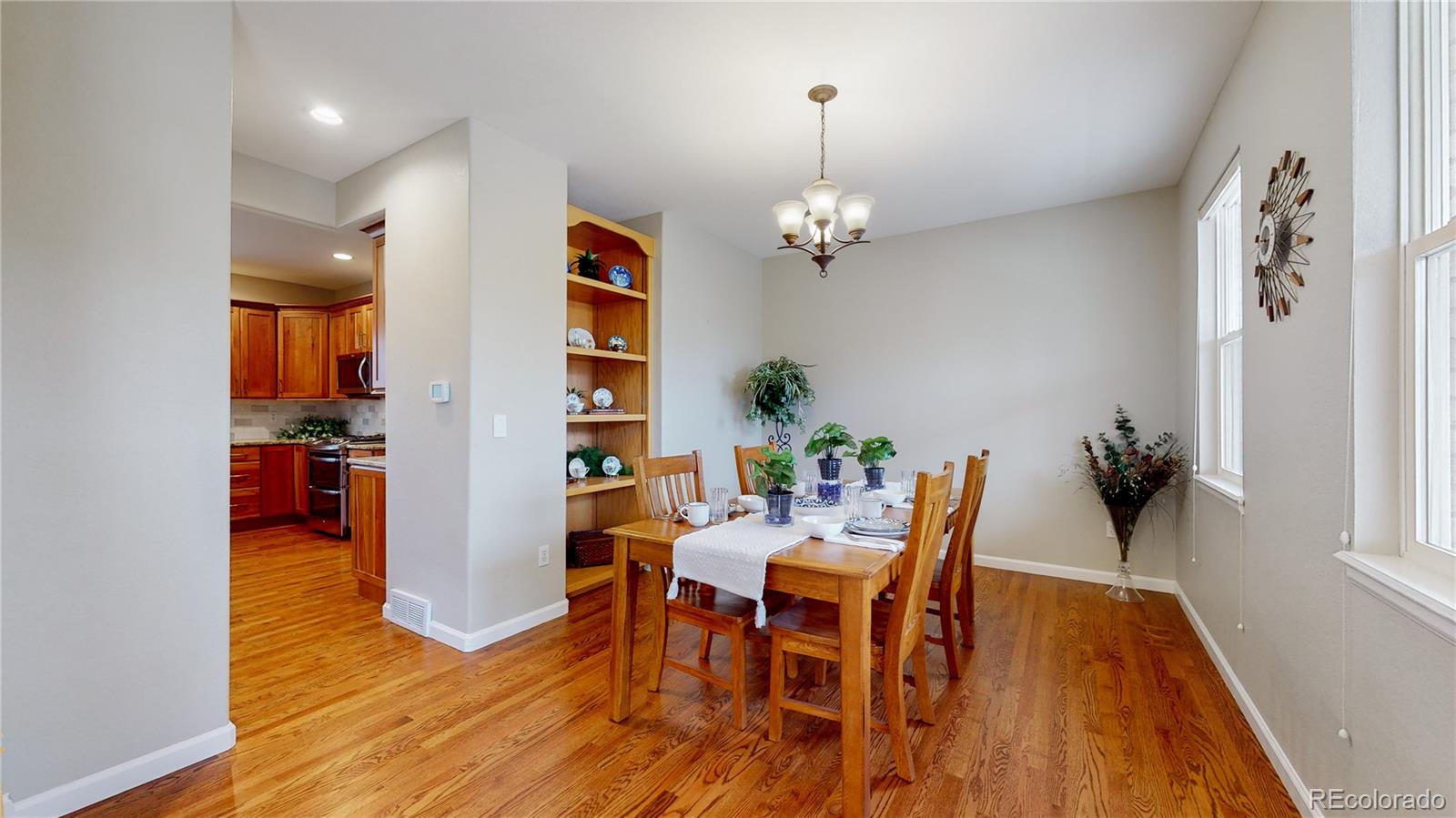 Undisclosed Address Longmont, CO 80504 - Photo 11 of 40 a view of a dining room with furniture and wooden floor