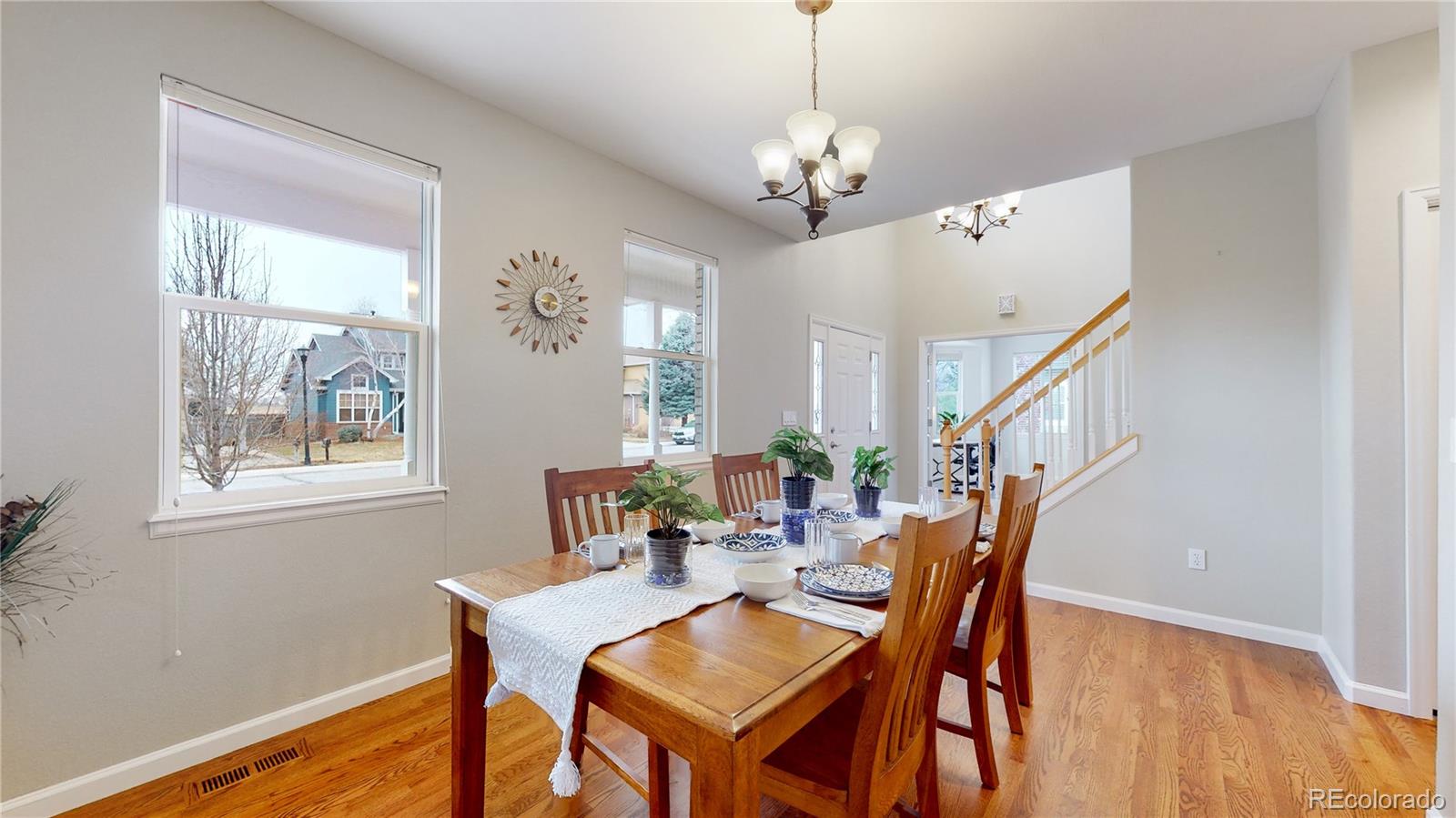 Undisclosed Address Longmont, CO 80504 - Photo 13 of 40 a view of a dining room with furniture wooden floor and chandelier