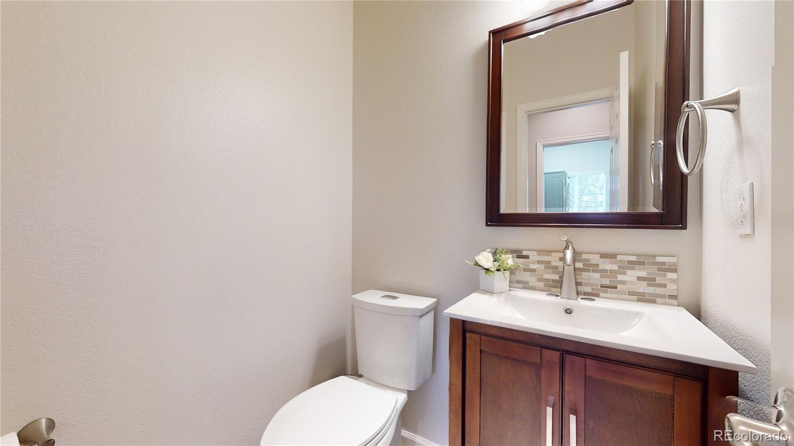 Undisclosed Address Longmont, CO 80504 - Photo 18 of 40 a bathroom with a toilet sink and mirror