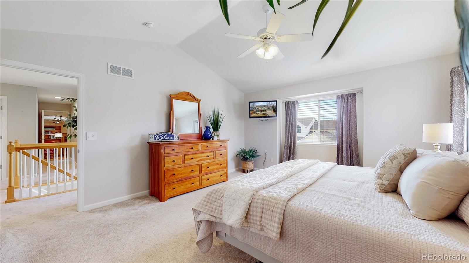 Undisclosed Address Longmont, CO 80504 - Photo 21 of 40 a bedroom with a bed and a chandelier