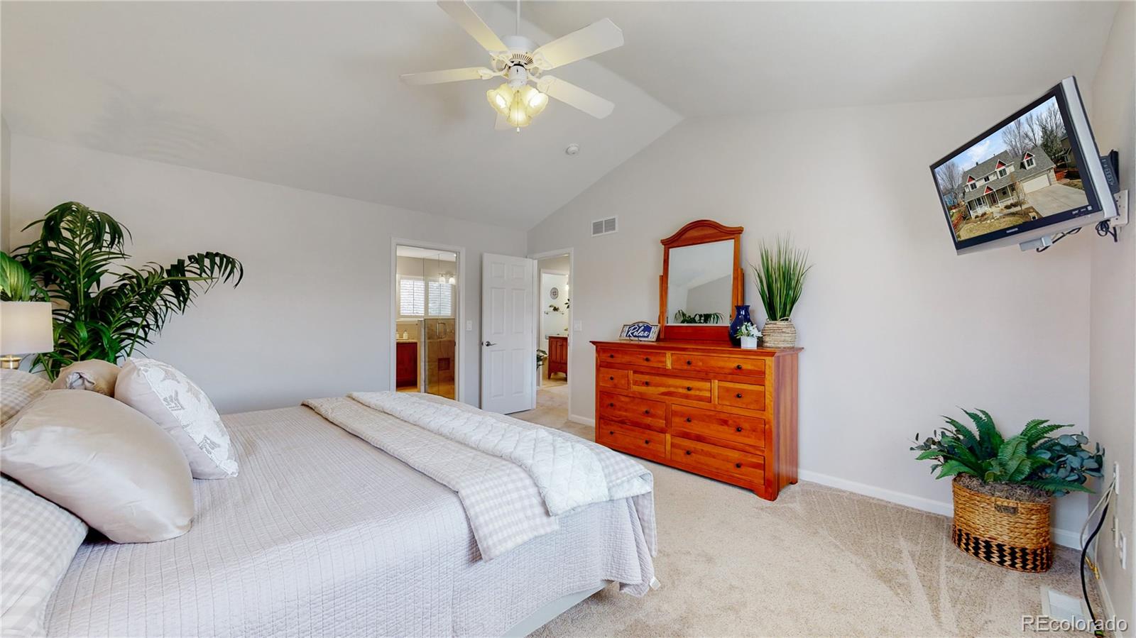 Undisclosed Address Longmont, CO 80504 - Photo 22 of 40 a bedroom with a bed and a chandelier