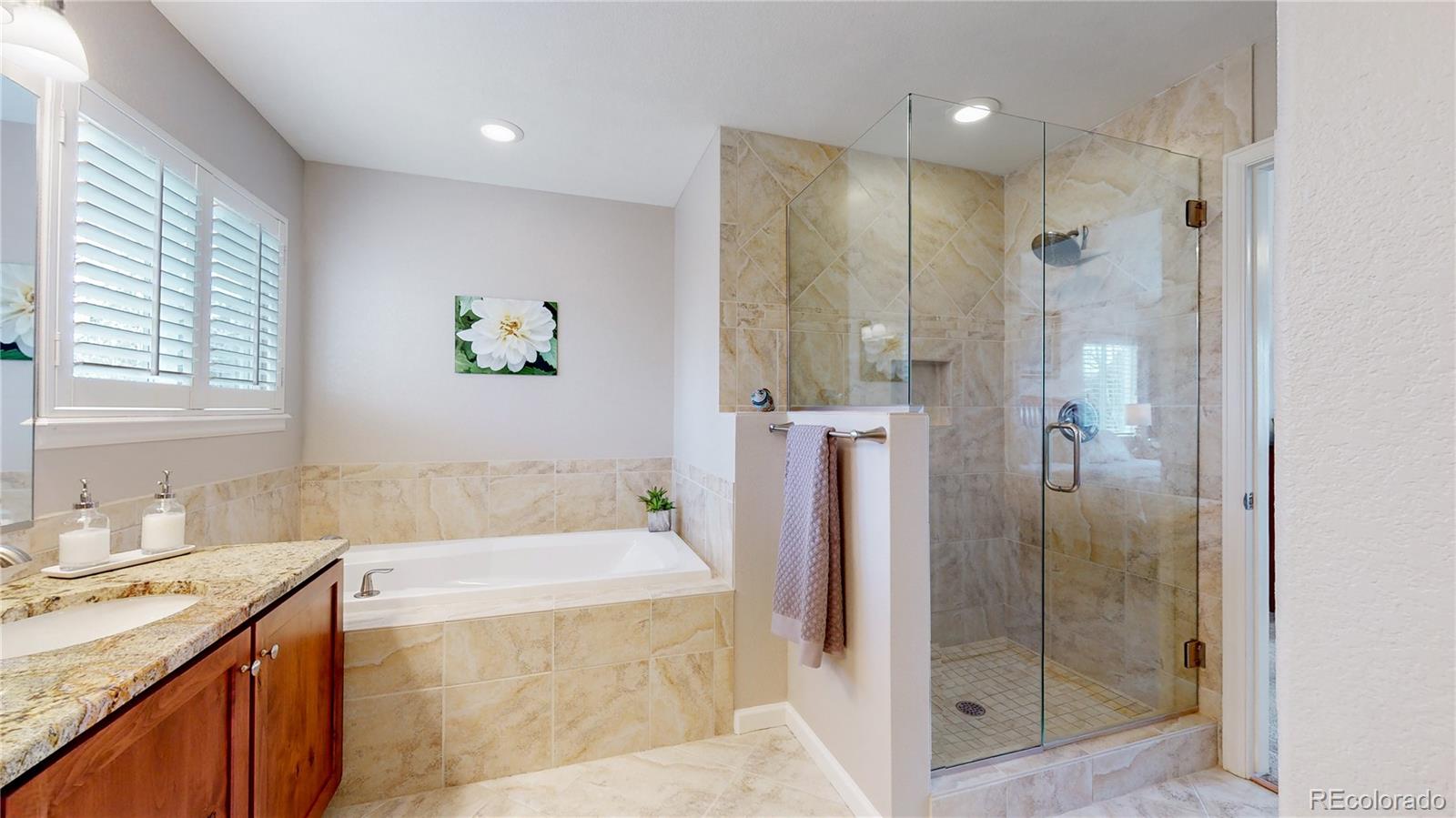 Undisclosed Address Longmont, CO 80504 - Photo 24 of 40 a bathroom with a tub sink and shower