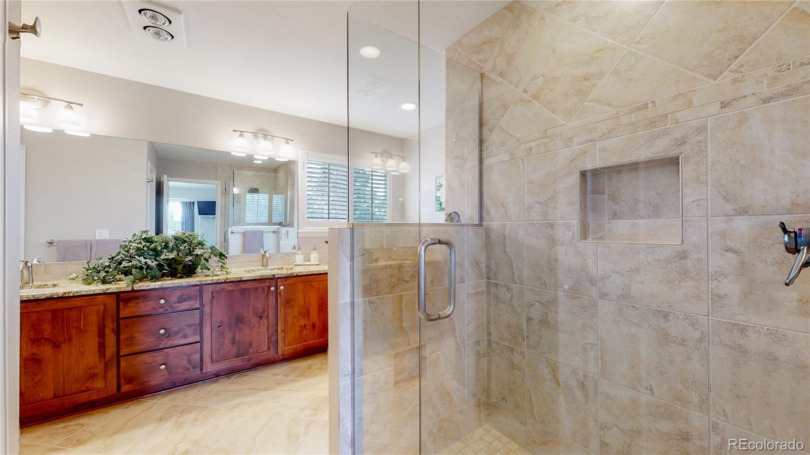 Undisclosed Address Longmont, CO 80504 - Photo 25 of 40 a bathroom with a granite countertop sink a mirror and shower
