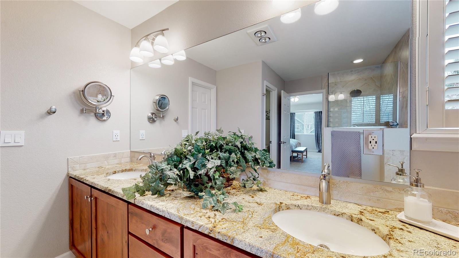Undisclosed Address Longmont, CO 80504 - Photo 26 of 40 a bathroom with a granite countertop sink a large mirror and shower