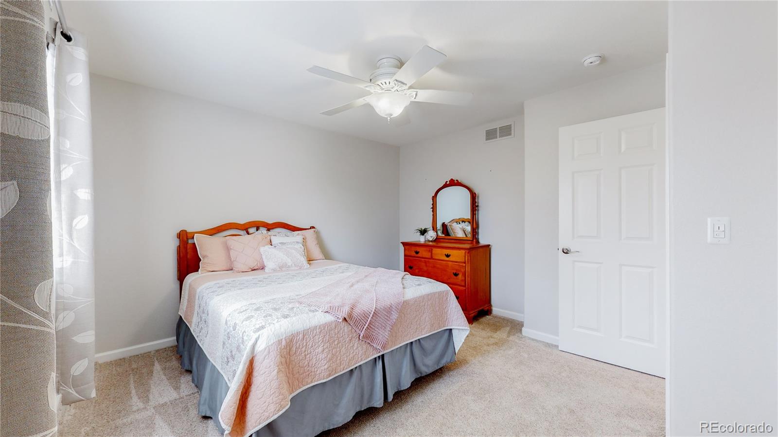 Undisclosed Address Longmont, CO 80504 - Photo 27 of 40 a bedroom with a bed and a chandelier
