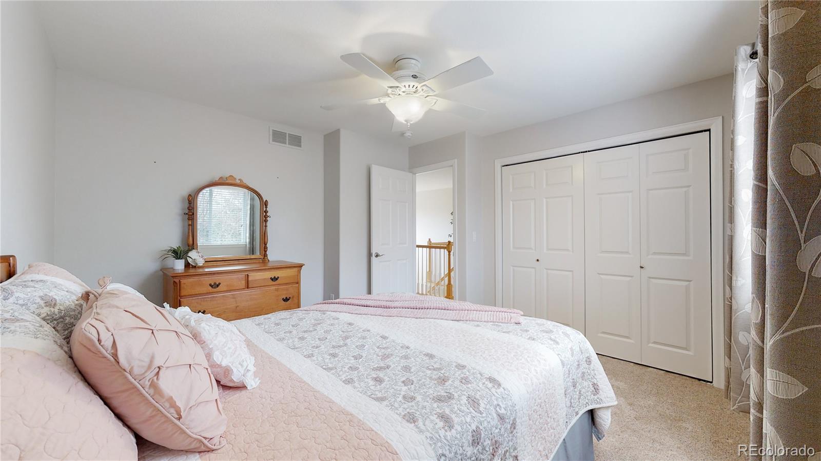 Undisclosed Address Longmont, CO 80504 - Photo 28 of 40 a bedroom with a large bed and a chandelier