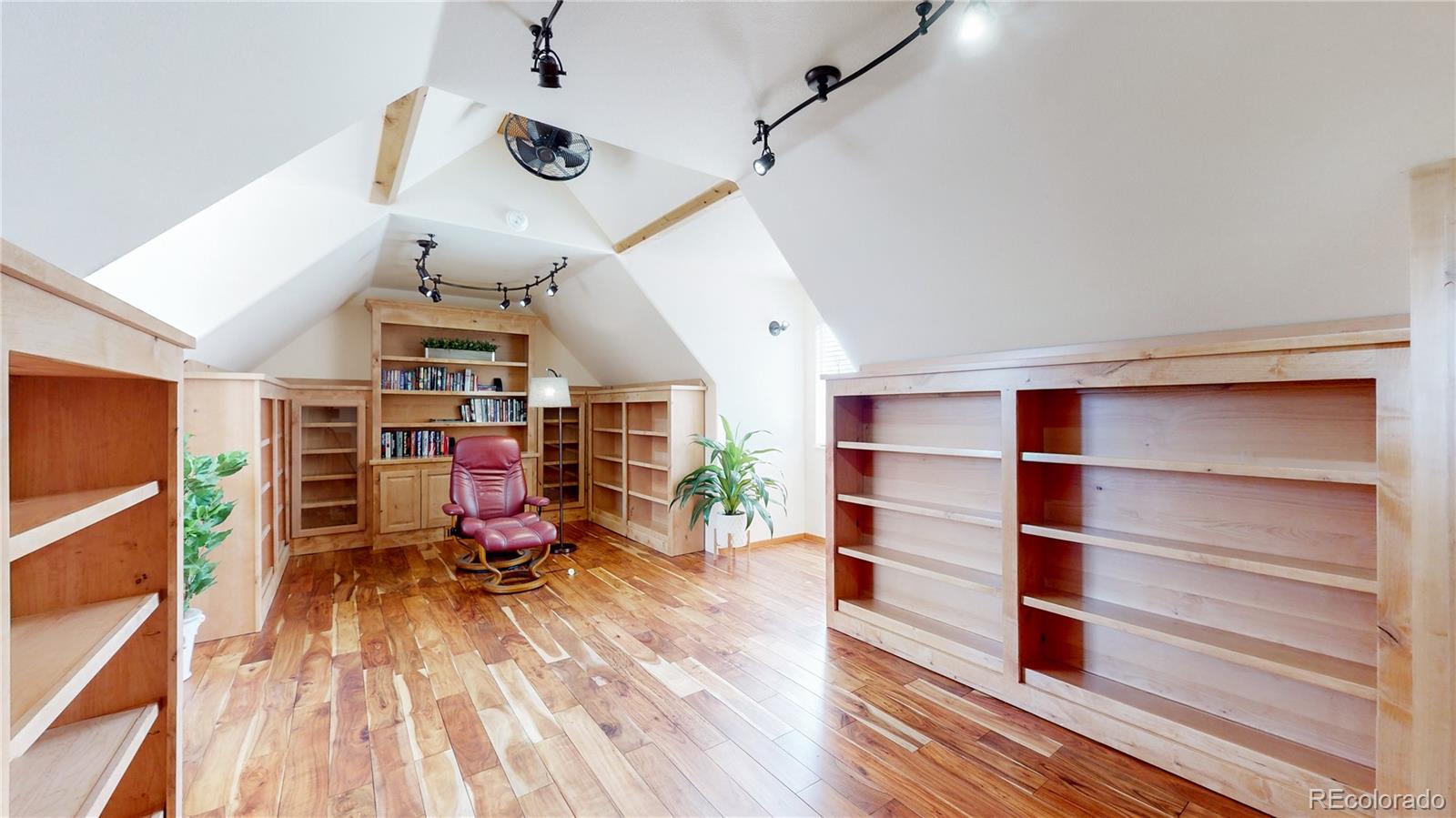 Undisclosed Address Longmont, CO 80504 - Photo 31 of 40 a view of a room with wooden floor and lots of shelves