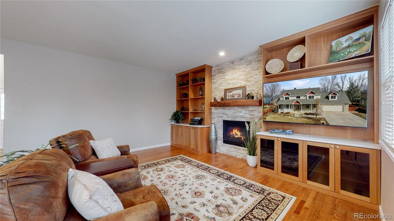 Undisclosed Address Longmont, CO 80504 - Photo 6 of 40 a living room with furniture a flat screen tv and a fireplace