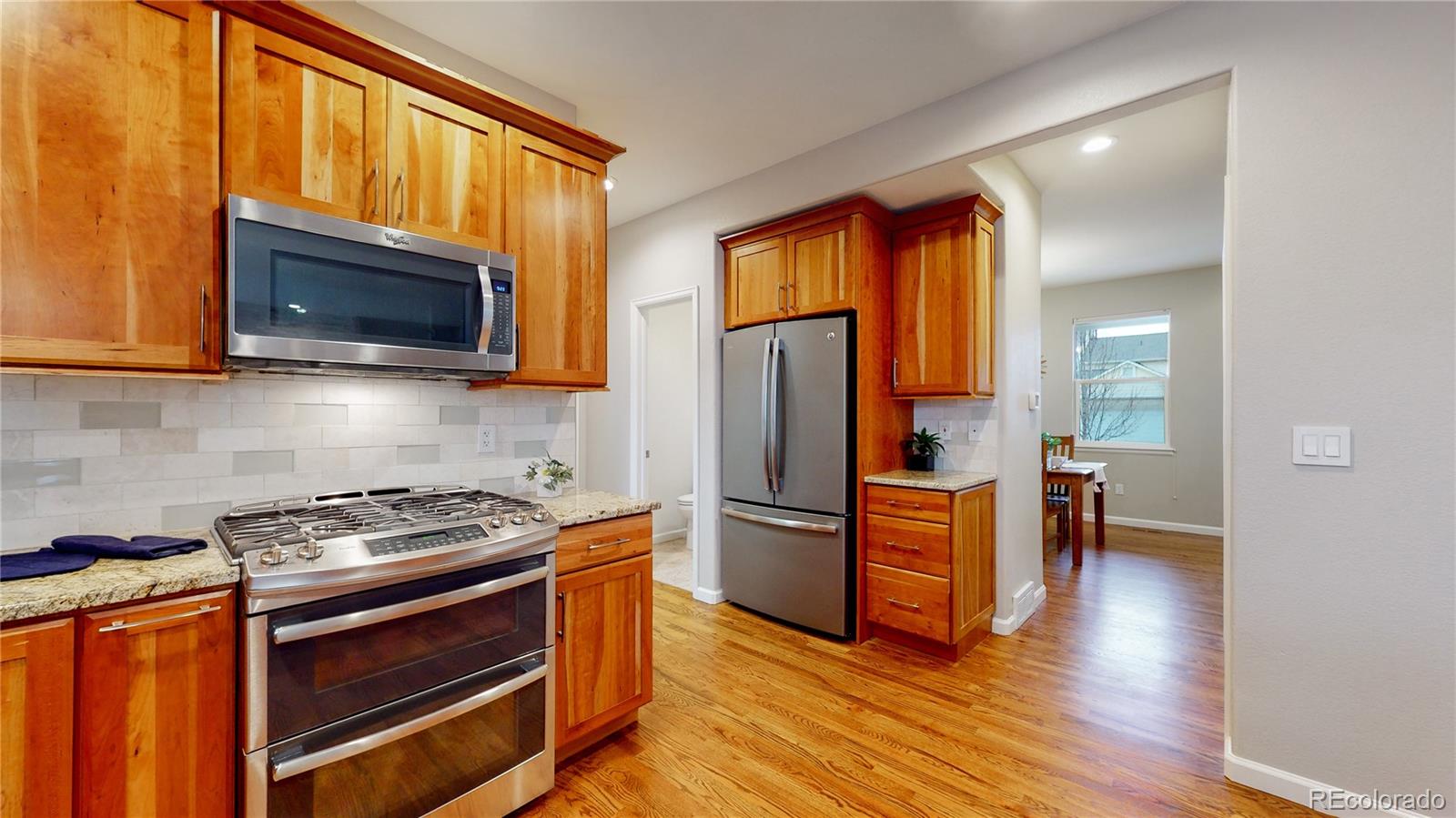 Undisclosed Address Longmont, CO 80504 - Photo 7 of 40 a kitchen with wooden floors and stainless steel appliances