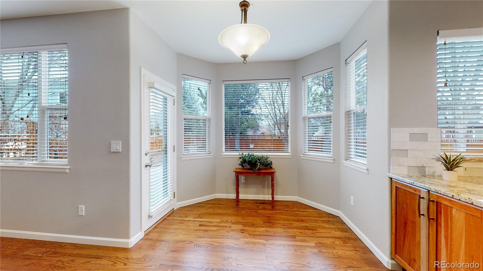Undisclosed Address Longmont, CO 80504 - Photo 10 of 40 a view of an empty room with window and wooden floor
