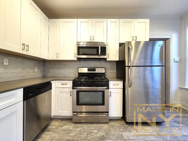 a kitchen with a refrigerator stove and microwave