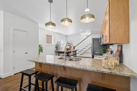 a kitchen with stainless steel appliances granite countertop a stove a sink and a microwave