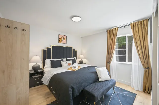 a bedroom with a bed and wooden floor