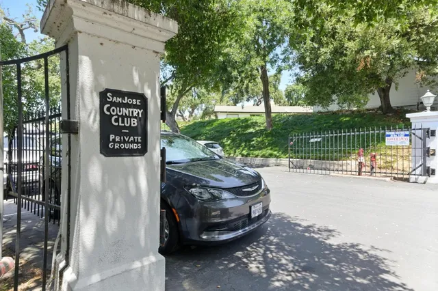 a view of a street with a car park in front of the house