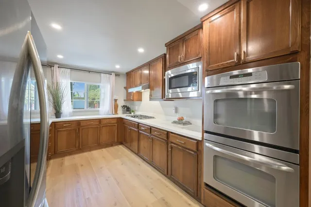 a kitchen with a refrigerator stove and sink
