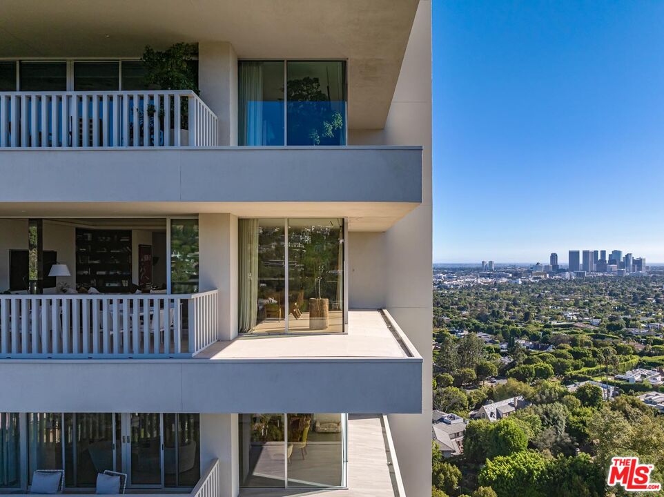 9255 Doheny Road, Unit 1901 West Hollywood, CA 90069 - Photo 19 of 23 a front view of a house with a garden and porch