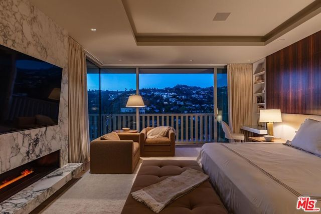 a balcony with furniture and a flat screen tv